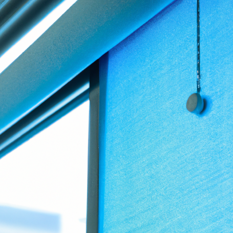 Close-up of a blue roller blind with a pull cord and chain mechanism.